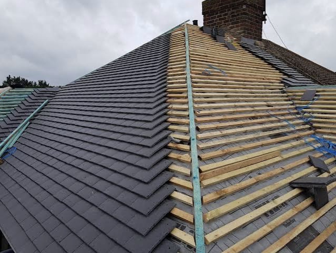 Slate reroof in progress with new timber battens and chimney