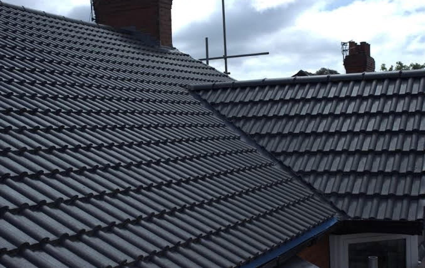 New anthracite interlocking tiled roof with chimneys