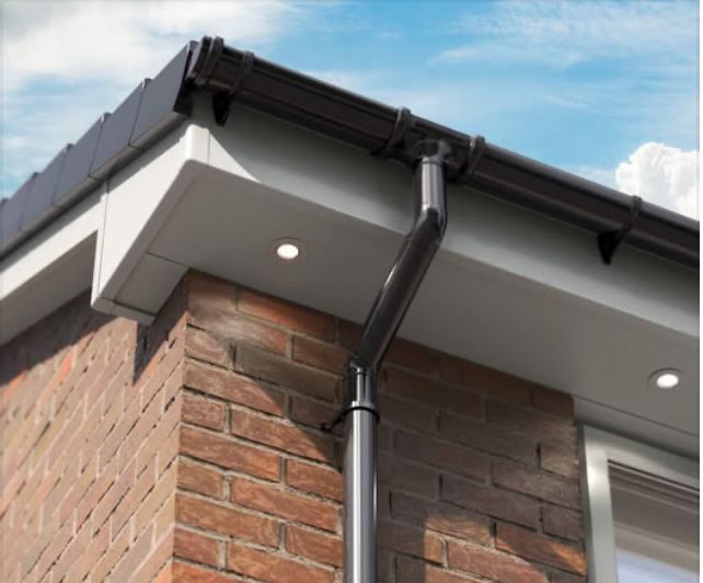 New white UPVC fascias and soffits with black guttering and downpipe
